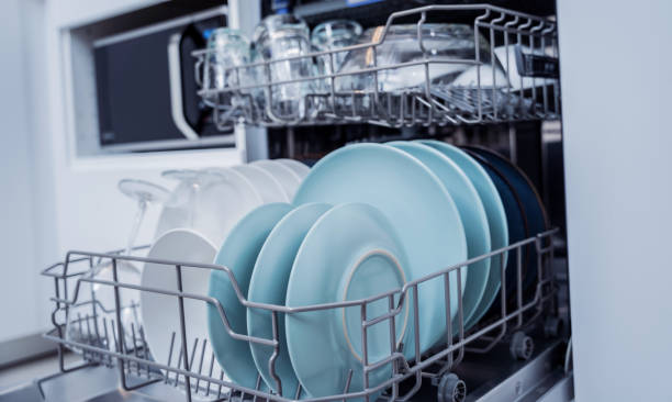 istock The white kitchen and opened dishwasher with clean dishes 2019913444
