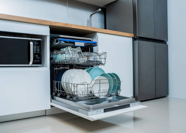 istock The white kitchen and opened dishwasher with clean dishes 2019920915