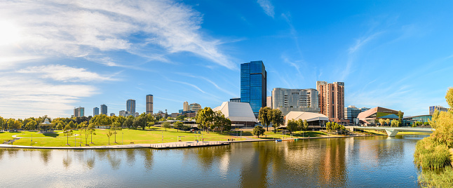 Adelaide, South Australia - February 17, 2024: Modern Adelaide City Business District skyline panorama on a bright morning viewed across the Torrens river from the bridge balcony