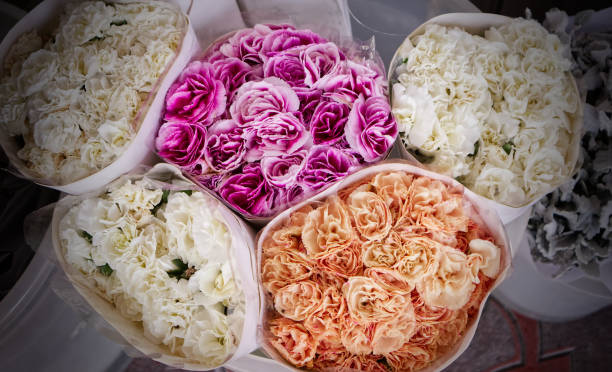 Group of flower bouquets wrapped in paper, colorful background