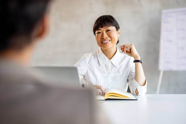 istock Young woman doing a job interview in the office and talking with client 2019980913