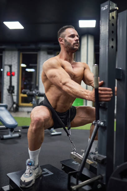 istock Concentrated muscular man, doing squats with weight. 2019988201