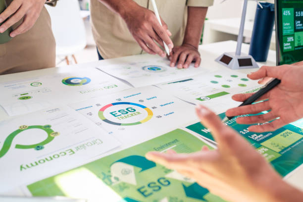 diversity team brainstorming focused on esg (environment,social,governance)  for sdgs goals in a sustainable green office - 太陽光パネル 書類 ストックフォトと画像