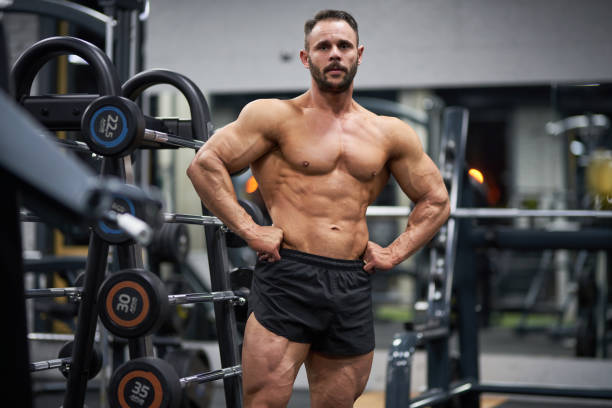 istock Confident bodybuilder posing with hands on waist to camera. 2019992914