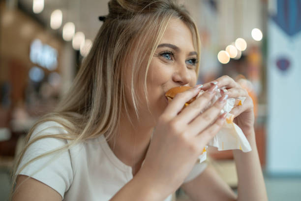 istock Woman Enjoying Delicious Burger 2020010278