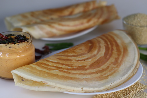 Proso Millet Dosa. South Indian crepe or dosa made with fermented batter of proso millet and lentils. Crispy texture, golden brown perfection, ideal for vegan, gluten free, healthy food enthusiasts