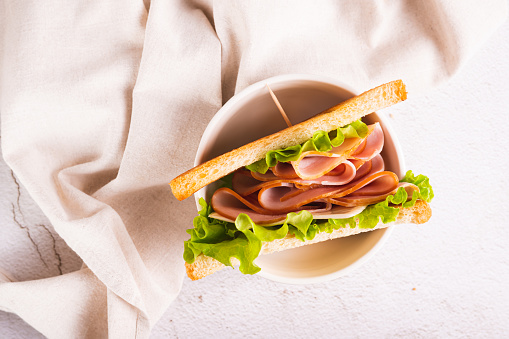 Close up of sandwich with ham, cheese and onion in a bowl on the table top view