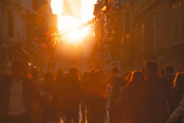 istock Crowd on street in bright lens flare 2020047048