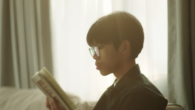 Asian Teenage reading a book.