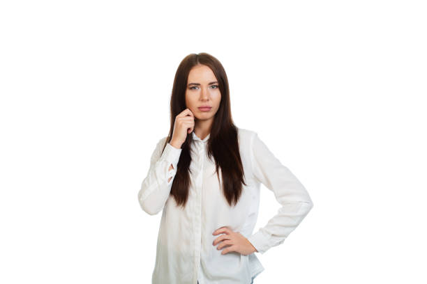 Calm young, beautiful girl in a whhte shirt on a white background.