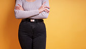 midsection of woman wearing tight black jeans