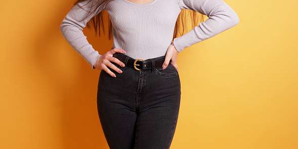 midsection of unrecognizable young curvy woman wearing tight black jeans