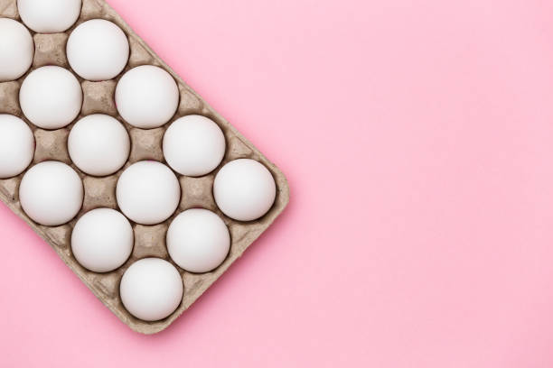 istock White  eggs in box close-up on pink background - stock photo 2020140704