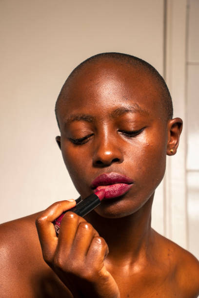 istock A woman putting on lipstick 2020144576