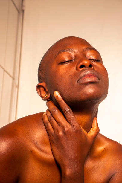 istock A woman with her hand on her neck 2020145660