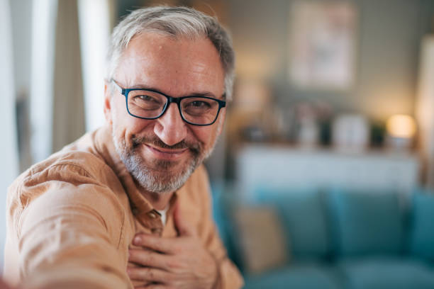 istock Man holding hand oh his chest and smiling 2020148392
