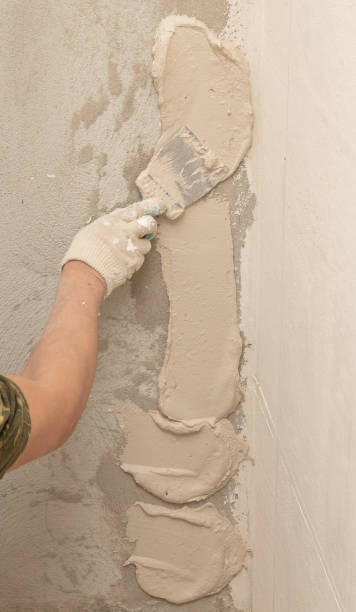 istock A worker is plastering the walls of a house under construction 2020165864