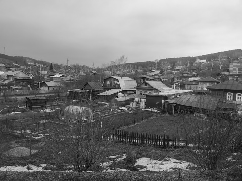 Village in the mountains in winter, black and white photo.