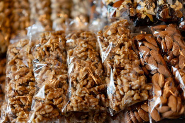 Variety of nuts packed in plastic bags at a charcuterie - No people