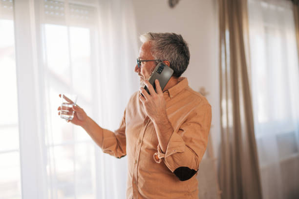 istock Mature man at home talking on the Phone 2020185410