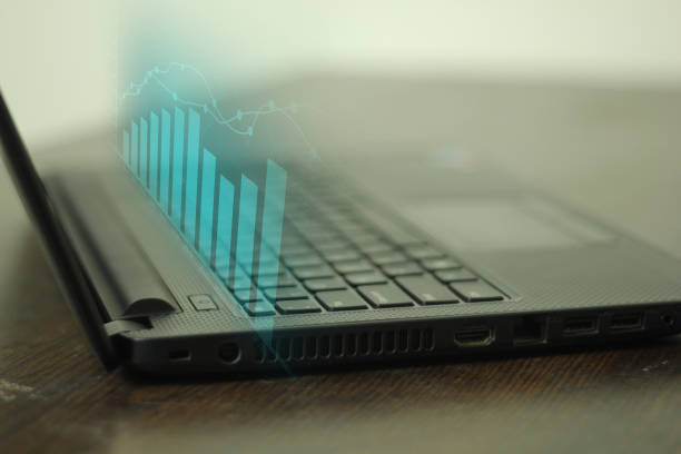 Business growth concept and laptop showing 3D financial chart technology background.