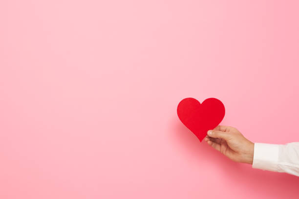 istock Man hand with paper heart figure 2020212124