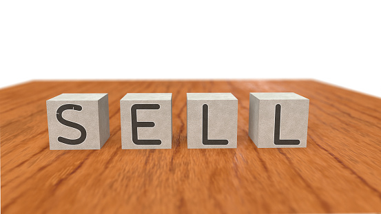 Sell word and wooden cube on white background.