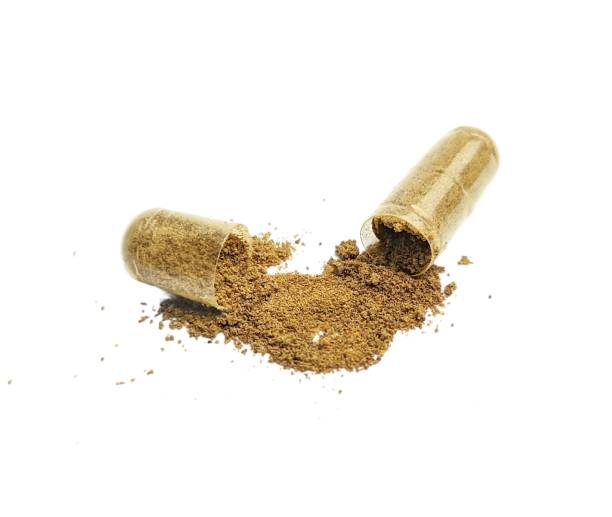istock Powdered herbal capsule medicine isolated on white background 2020217421