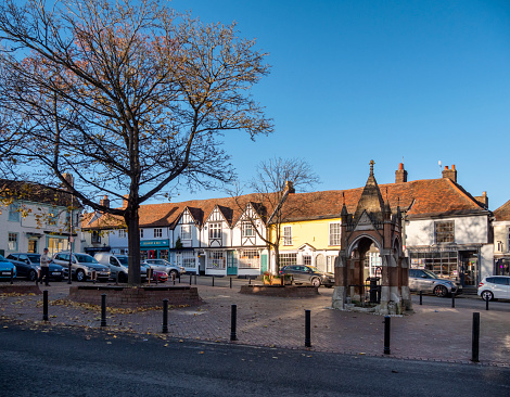 The Market Square in Woodbridge, Suffolk, Eastern England, where the weekly Thursday food and produce market is held. To the right is the Victorian Gothic style town water pump house, constructed in 1876. Woodbridge has many old buildings and is an attractive town beside the River Deben.