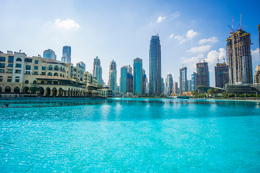Dubai, UAE - December 6. 2019 - The turquoise water of the Dubai fountain with view to Burj Khalifa