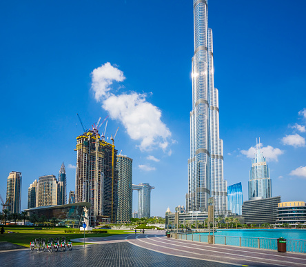 Dubai, UAE - December 6. 2019 - The turquoise water of the Dubai fountain with view to Burj Khalifa