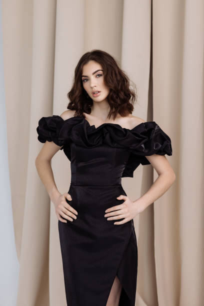 istock A woman in a black dress poses. 2020234908