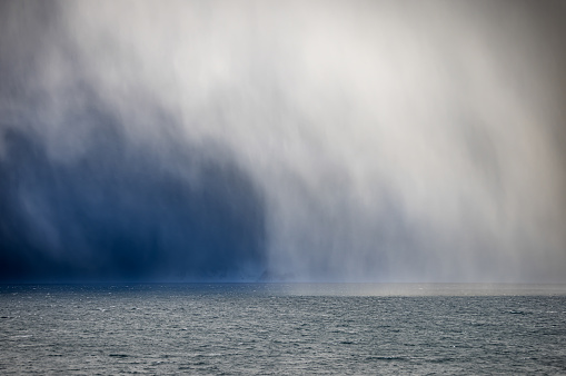 A tropical storm over a fresh water lake in a tropical setting.