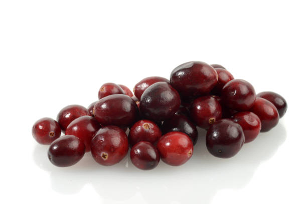 istock pile of fresh cranberries on white 2020285805
