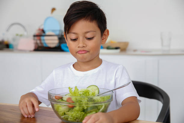 istock Unhappy Little Boy Dislike Green Salad 2020306149