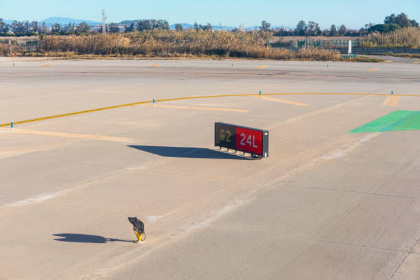 Airport sign on the runway of the airport in a sunny day