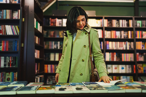 Part of a series of an Asian Woman spending time in a Bookstore.