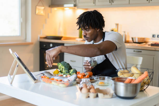 istock Man following an online cooking course 2020435250