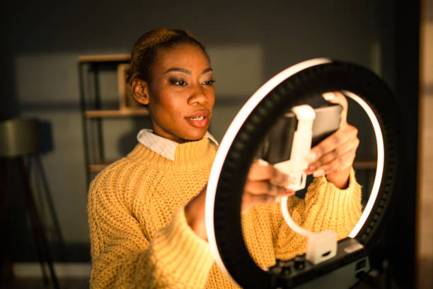 istock A woman adjusting a cellphone on a selfie ring light 2020452336