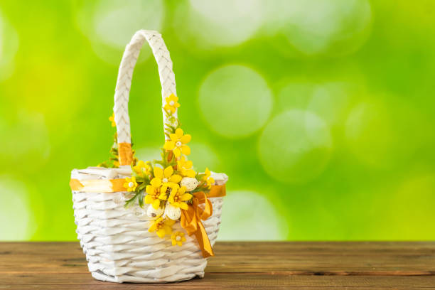 Easter white basket on a background of beautifully blurred greenery, Concept, spring season, happy Easter, copy space