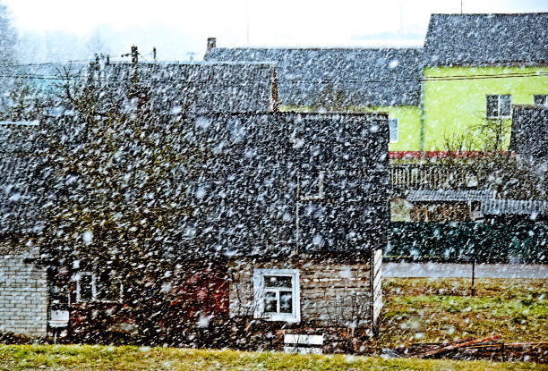 istock Snow falling heavily in a quaint village on a desolate winter day with a cold and gloomy atmosphere 2020470109