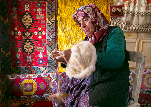 Taskale,Karaman,Turkey,September 20, 2015: A woman spinning wool with Kirman