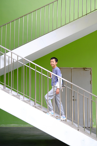 Little boy climbing up the stairs