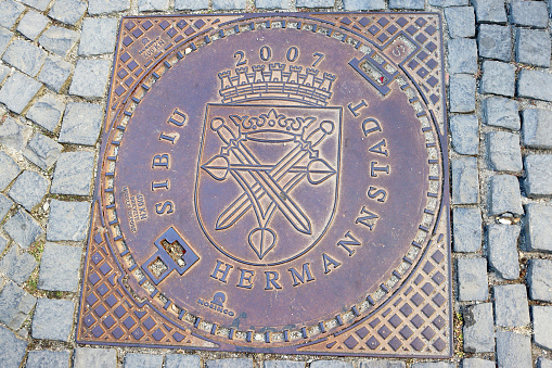Sibiu, Romania - October 14, 2023: Manhole cover with coat of arms
