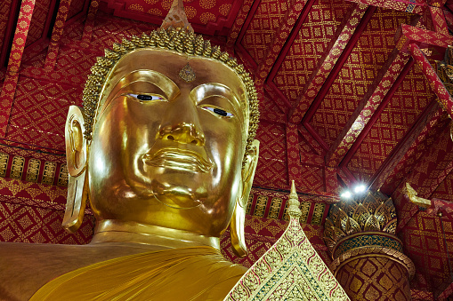 Ayutthaya, Thailand - August 22, 2015: Buddha image is in chapel of Wat Suwandararam, Ayutthaya, Thailand. The interior of chapel is Thai crafts and art.
