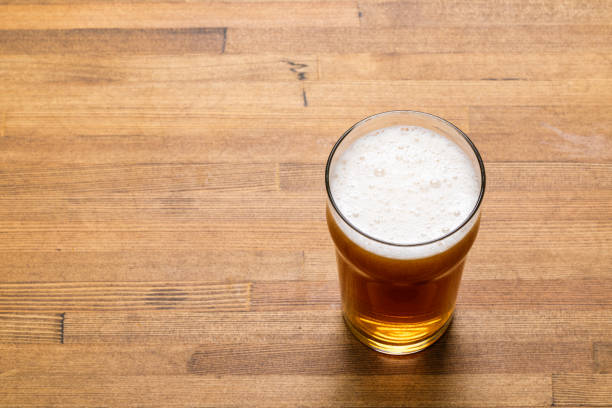 istock Craft beer in pint glass on a wooden table 2020498842