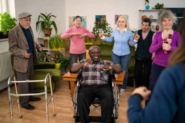 istock Mature care home residents enjoy an exercise class together 2020503174