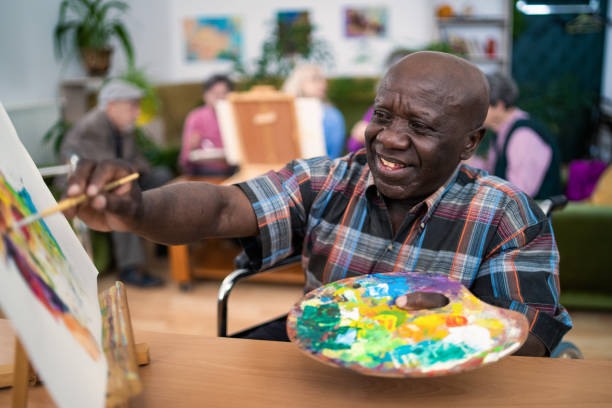 istock Senior artist painting on canvas 2020503689