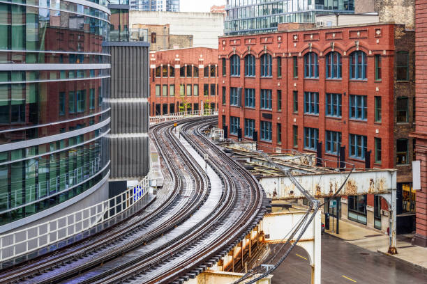 istock Curving elevated railway tracks through a downtown district with both modern and traditional buildings 2020522398