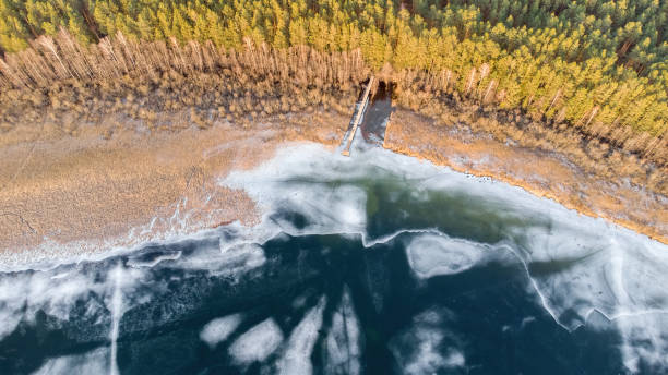 istock Lake shore in winter from above. Winter antics, art 2020526647